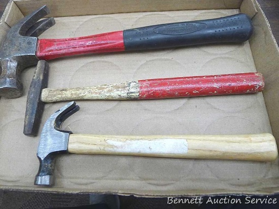 Two claw hammers and an upholstery hammer up to 13-1/2" long. Smallest head is about 3-3/4".