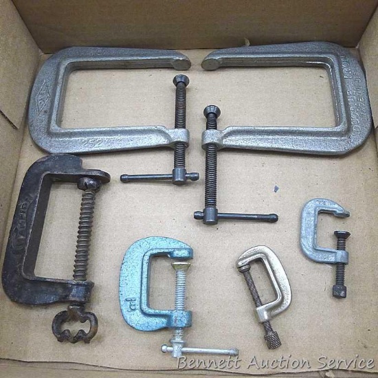 Six C-clamps, two by Ductile Iron. Larger are 4-1/2" x 3-3/4". Champion clamp has fancy knob.