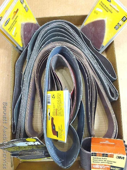 Sanding belts, discs, and sheets in varying grits, some NIP. Larger belts are roughly 2" x 22" long.