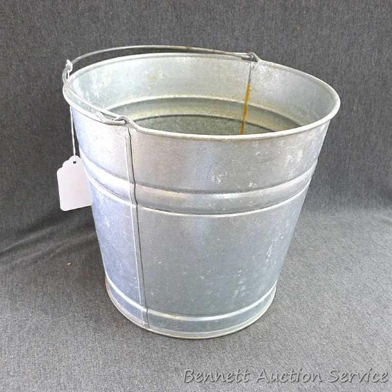 Galvanized pail with the number 12 embossed on the bottom; measures 11" x 10" tall.