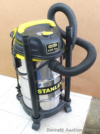 Stanley 5 gallon rolling wet/dry shop vacuum comes with a few different nozzles. Runs but doesn't