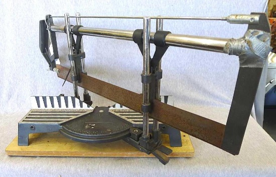 Nice miter box with metal cutting saw about 27-1/2" long overall. Miter box mounted on a 18" board.