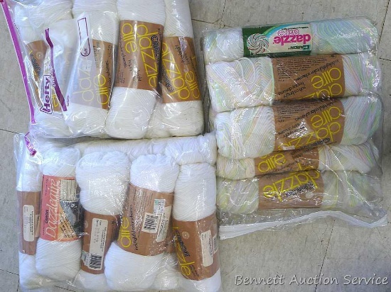 Several skeins of Caron yarn incl white, yellow, blue and multicolor.
