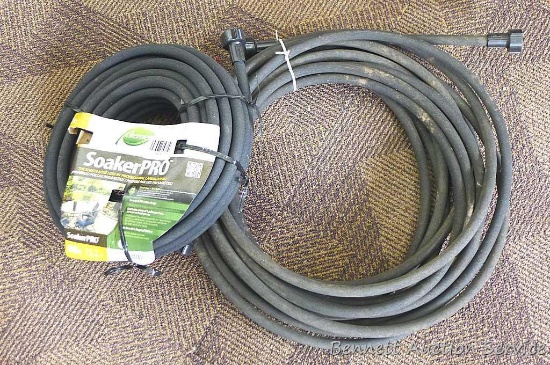 Two soaker hoses. One is marked 50' and both look to be in good condition.