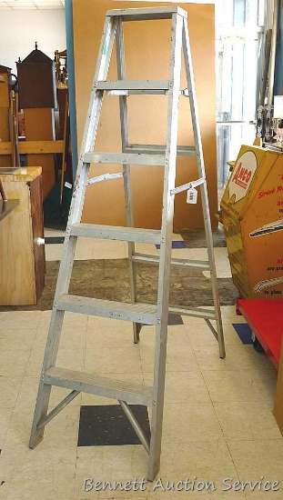 Tall, sturdy, aluminum ladder which measures approx.. 69" x 44" x 21".