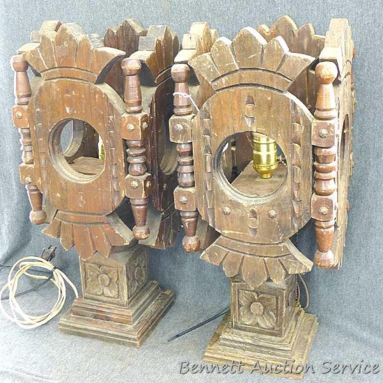 Two unique matching intricately wood carved lamps. Lamps measure approx.. 8" x 8" x 20".