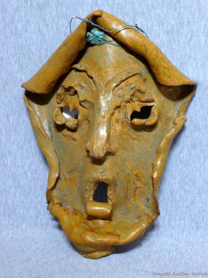 Pottery mask used as decoration. Piece has a unique design and would make an interesting art piece