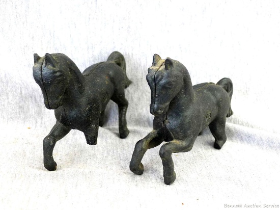 Two cast iron horse banks. Legs are broken on both horses, but are in otherwise good condition.