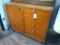 Sturdy solid wood cabinet would make a great smaller buffet or bar cabinet. Measures 34