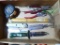 Assorted hand tools including a 25' tape measure, pliers, knives and more.