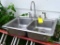 Nice stainless steel kitchen sink with faucet; measures 33