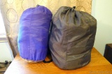 Two sleeping bags in sacks.
