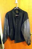 Dunbrook men's size Medium jacket has a wool shell and leather sleeves. Jacket is in good condition