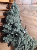 8' artificial Christmas tree, breaks down into 3 pieces; measures 3' at the base. This is located in
