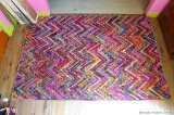 Very fun bright colored area rug; measures 4'11
