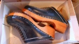 Leather and wood clogs have a rubber sole. No size found, but they measure 9