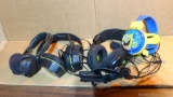 Four pairs of headphones including Turtle Beach, Afterglow and a pair of Sponge Bob.