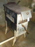 Enamel wood stove with AJ Lindemann & Hoverson Co., Milwaukee Wis. Kitchen heater embossed on front;