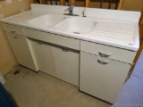 Vintage enamel double sink with wash board on either side and metal base; measures 66