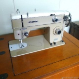 Vintage Nelco sewing machine in original cabinet. Classic piece in good condition. Cabinet measures
