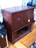 Vintage radio cabinet converted into a nice storage unit with 2 doors and shelves on the one side;