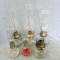 Two pairs of oil lamps plus two more in good condition. Larger of the two pairs have different size