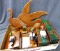 A quacky lot with desk top pieces, wooden wall decor, and Avon Collector Duck Series ducks. Wall