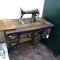 Antique Davis Vertical Feed treadle sewing machine with cabinet. Machine has decent graphics, wood
