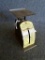 Vintage Deluxe Thrifty Postal Scale, weighs up to 1 lb. Scale is in nice shape, good vintage display