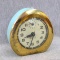 Cheery vintage Alpine alarm clock has a metal body and measures about 4