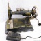 Antique Whippet sewing machine has nice graphics and still has foot pedal. Heavy cast base measures