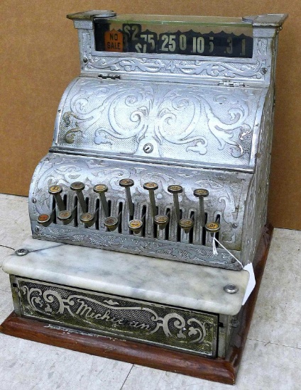 Neat old antique Michigan brand cash register has a marble shelf below keys or buttons, glass shelf