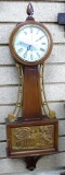 General Electric banjo style quartz clock runs. Measures approx. 27