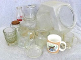 Collection of various glassware, cookie jar, milk glasses, cups, and more. Glass could use a good