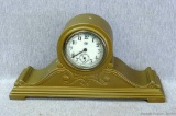 Attractive mantle clock has cast metal body and is about 11