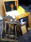 Lot of wooden picture frames, and pictures. Some frames have cracking and broken pieces, some frames