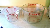 Located at alternate address in Prentice. Pair of glass Pyrex measuring cups are in good condition,