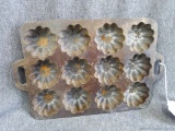 Unique cast iron cornbread or muffin pan is in good condition. Measures about 8
