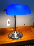 Located at alternate address in Prentice. Newer style banker's lamp has a blue glass shade and is