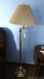 Located at alternate address in Prentice. Brass toned swing arm floor lamp, works. Stands nearly 5'