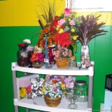 Located at alternate address in Prentice. Faux flower arrangements, footed glass display, canister,