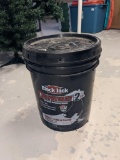 Located at alternate address in Prentice. 5 gallon bucket of driveway sealer feels full.