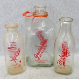 Fisher's Dairy glass milk bottle, Gruber Bros. Dairy gallon glass jug, and Filbert Dairy glass milk