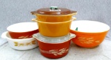 Pyrex ovenware bowl set. All are in good condition, some with covers. Largest bowl measures 8 1/2''