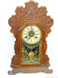 Beautifully ornate clock with wooden cabinet was manufactured by Waterbury Clock Co. USA. Seller