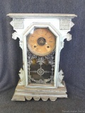 Antique shelf or mantle clock comes with key and pendulum. Front right foot is detached and