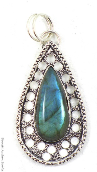 Beautiful iridescent blue tear drop pendant in silver-like setting, approx. 2" long. Would look