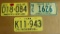 1961 and 1974 Wisconsin license plates, including Farm; 1968 Idaho license plate.