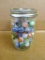 Jelly jar of old glass marbles.