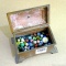 Clay and glass marbles in a 7'' cast bronze curio box.